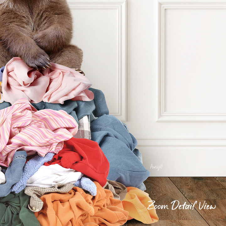 A pile of clothes, including various fabrics and colors, with a stuffed animal sitting atop it.