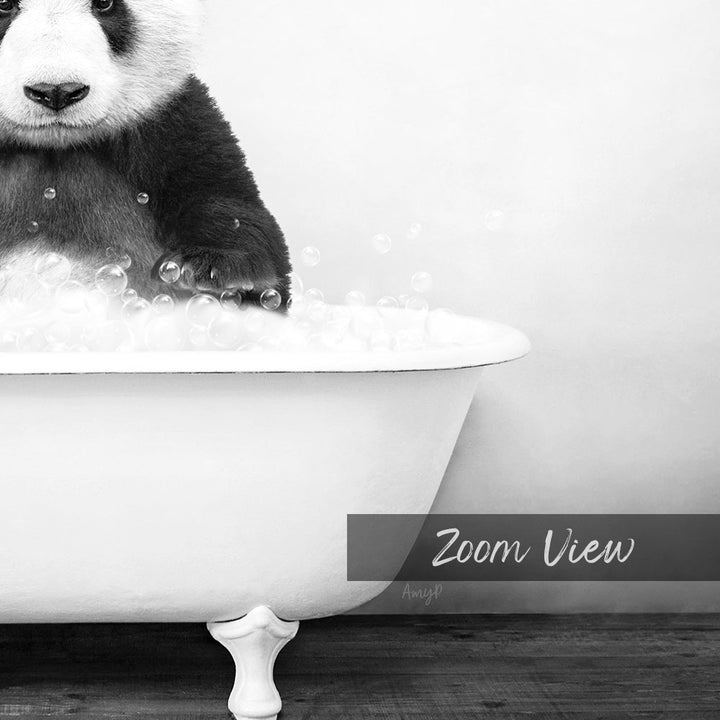 A panda bear sitting in a bathtub filled with bubbles, as captured in a black and white image.