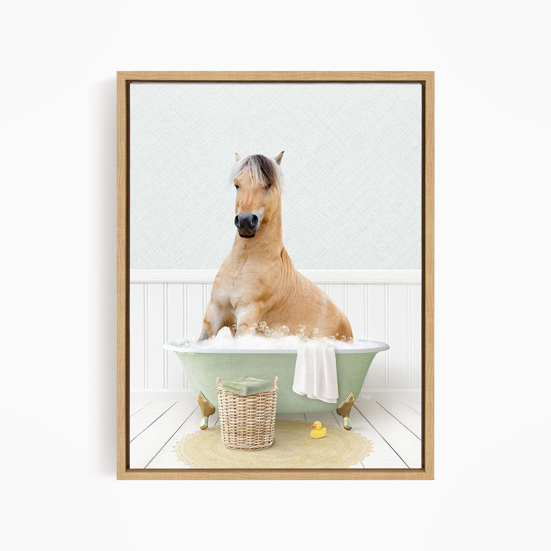 A light brown horse is sitting in a green bathtub filled with water, surrounded by a basket of toys and a yellow rubber duck.