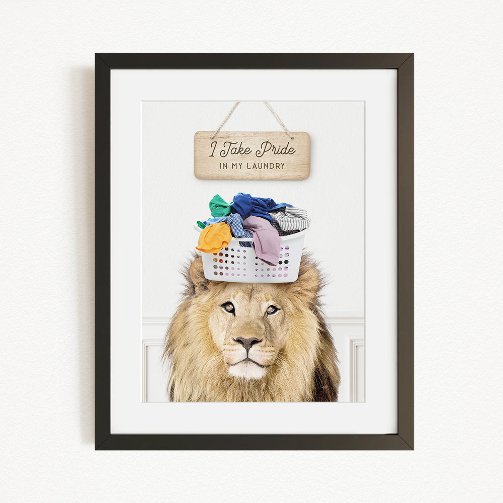 A framed image of a lion wearing a basket of laundry, with a sign above that says "I Take Pride in My Laundry".