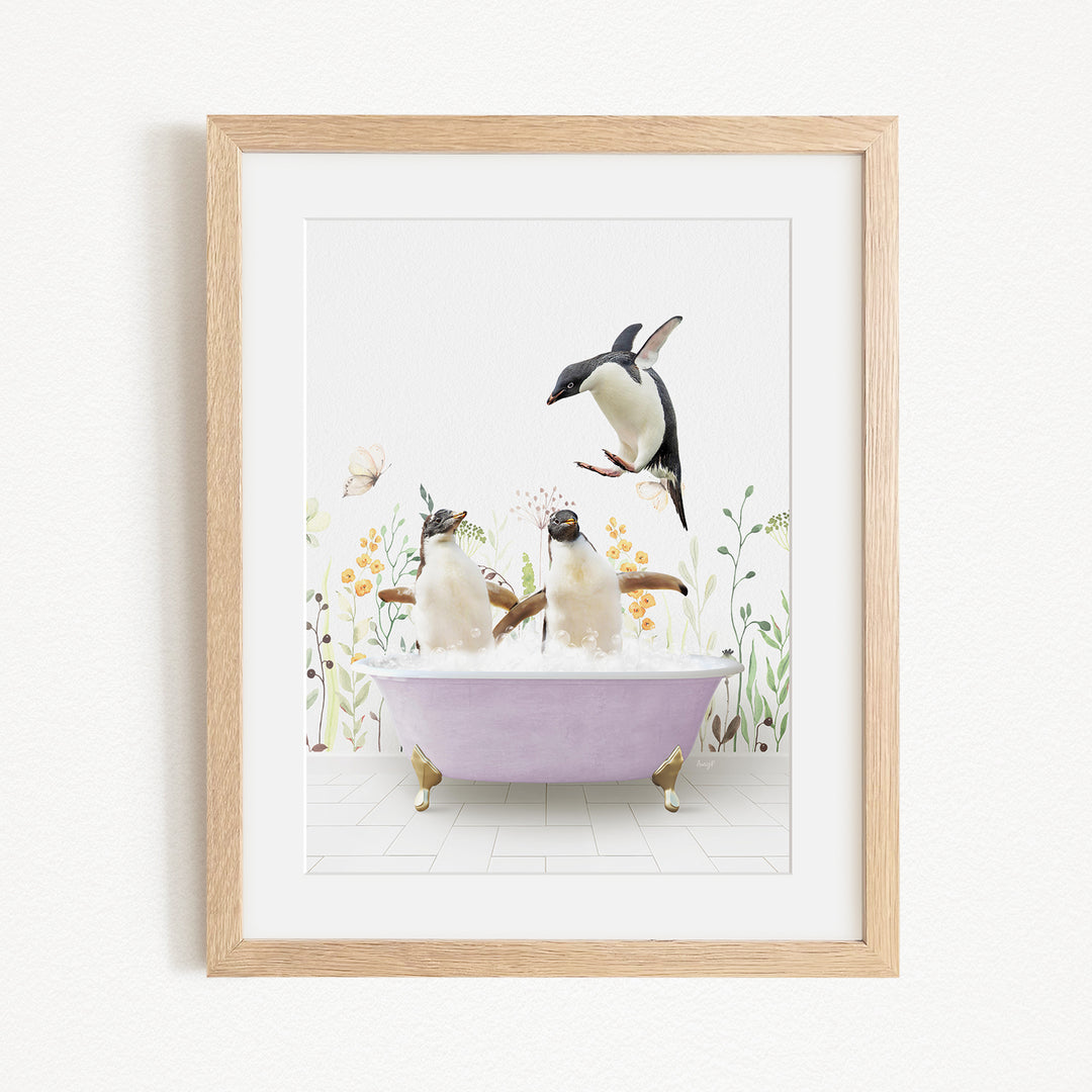 A framed image depicting two penguins sitting in a bathtub filled with bubbles, surrounded by flowers and butterflies.