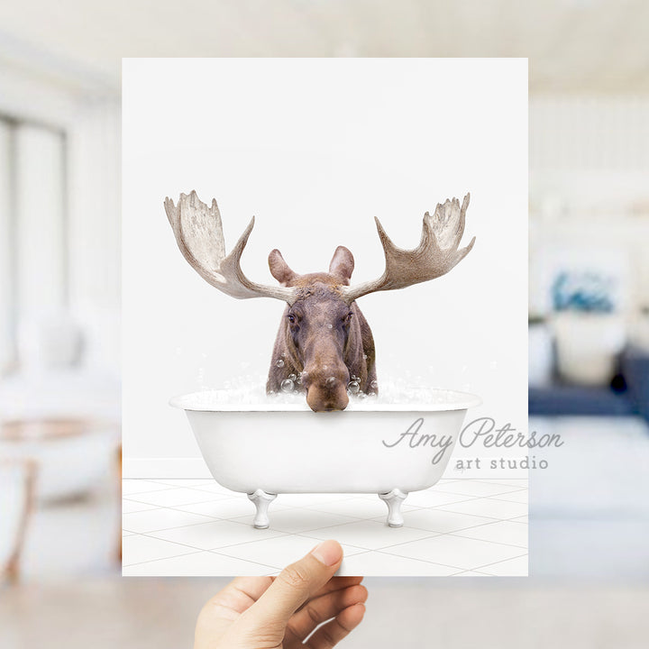 a person holding up a card with a picture of a moose in a bathtub