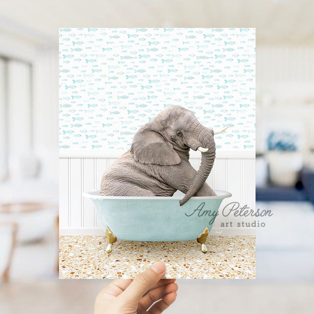 a person holding up a picture of an elephant in a bathtub