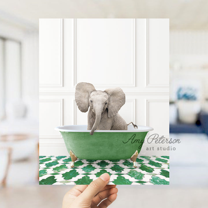 a hand holding a card with an elephant in a bathtub