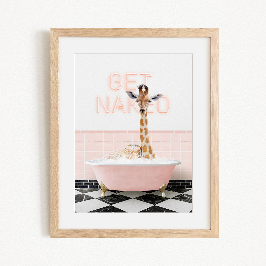 A giraffe standing in a pink bathtub with a sign that says "GET NAKED" in the background.