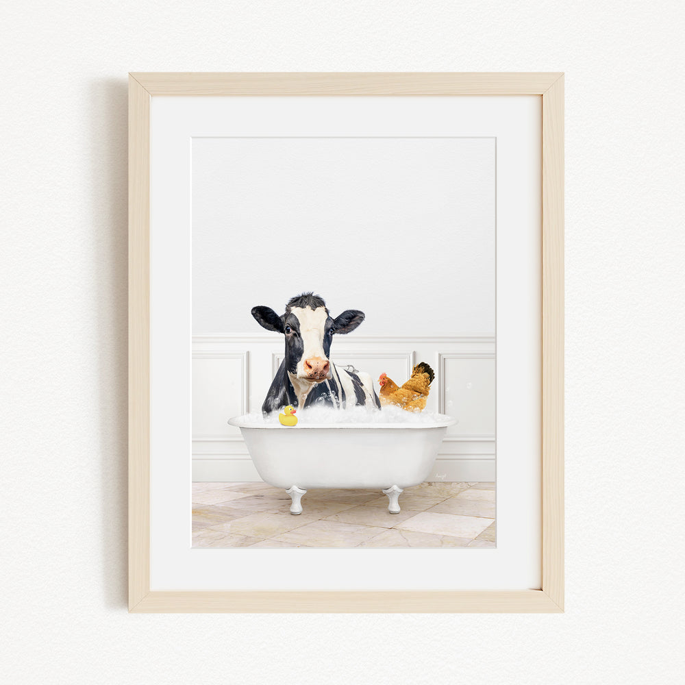 A black and white cow is sitting in a white bathtub, surrounded by a yellow rubber duck and a chicken, creating a whimsical and playful scene.