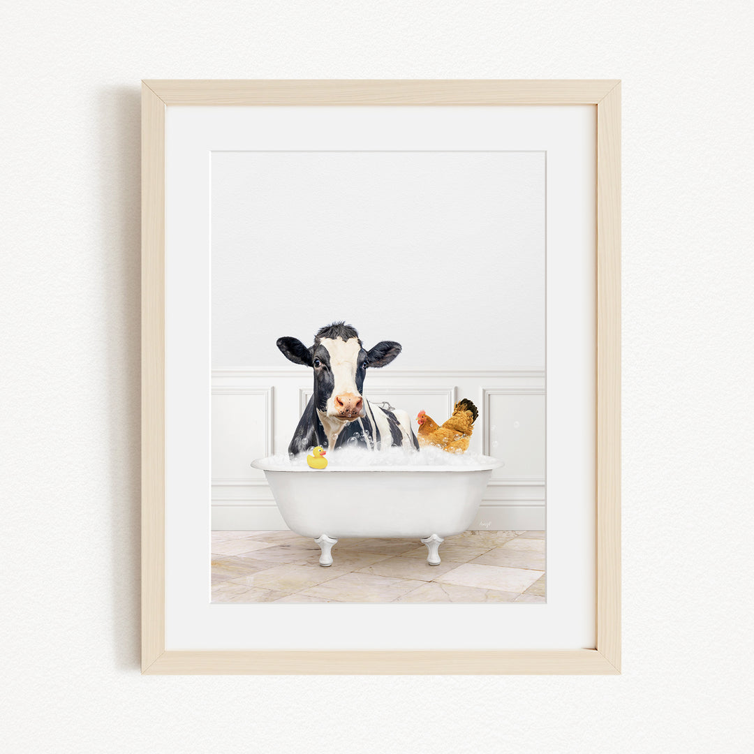 A black and white cow is sitting in a white bathtub, surrounded by a yellow rubber duck and a chicken, creating a whimsical and playful scene.
