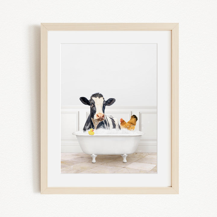A black and white cow is sitting in a white bathtub, surrounded by a yellow rubber duck and a chicken, creating a whimsical and playful scene.