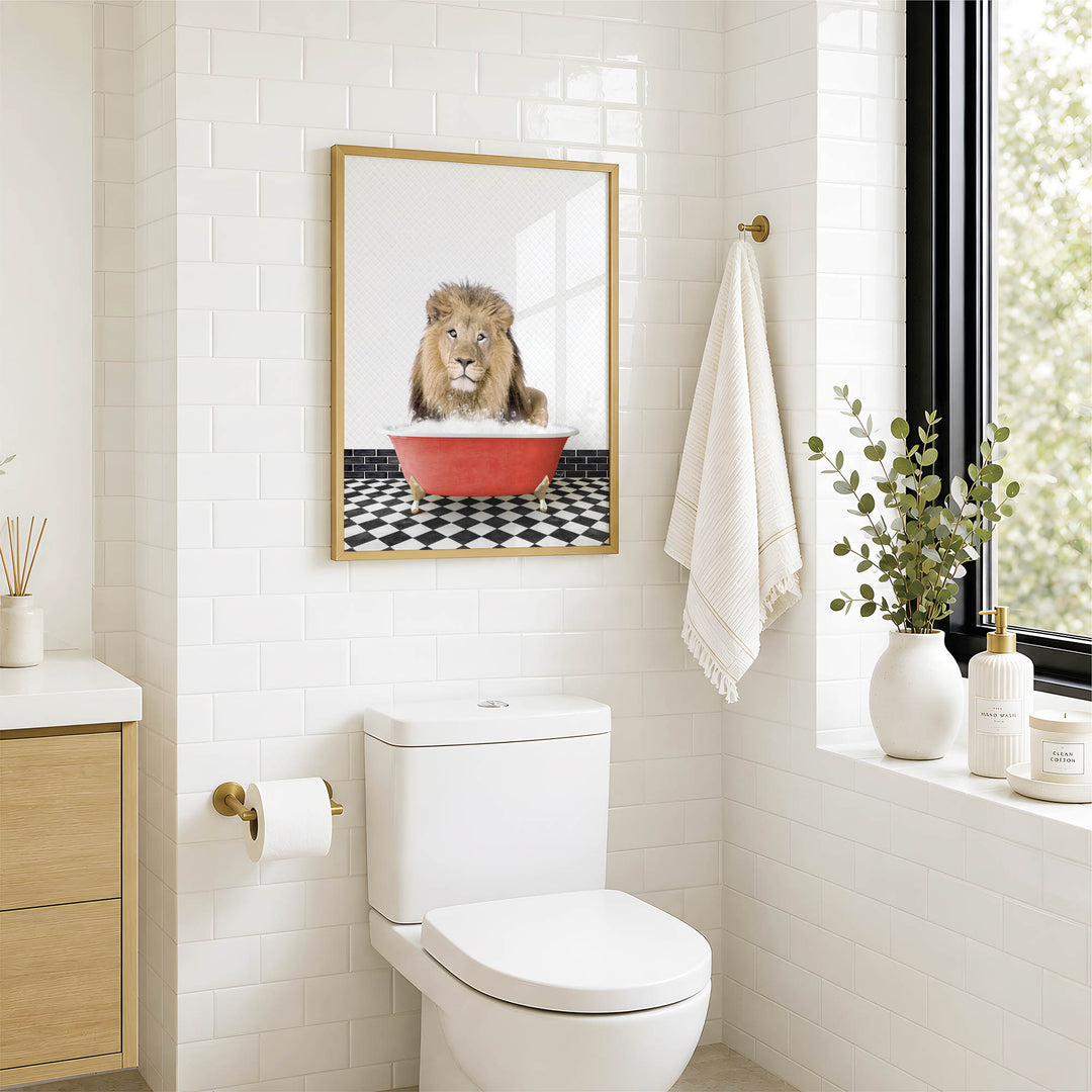 a bathroom with a white toilet, a framed picture of a lion in a red bathtub, and a towel hanging on the wall.