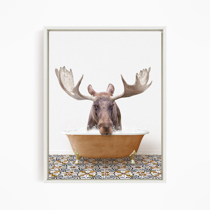 A moose with large antlers is sitting in a bathtub filled with water, creating a whimsical and humorous scene.
