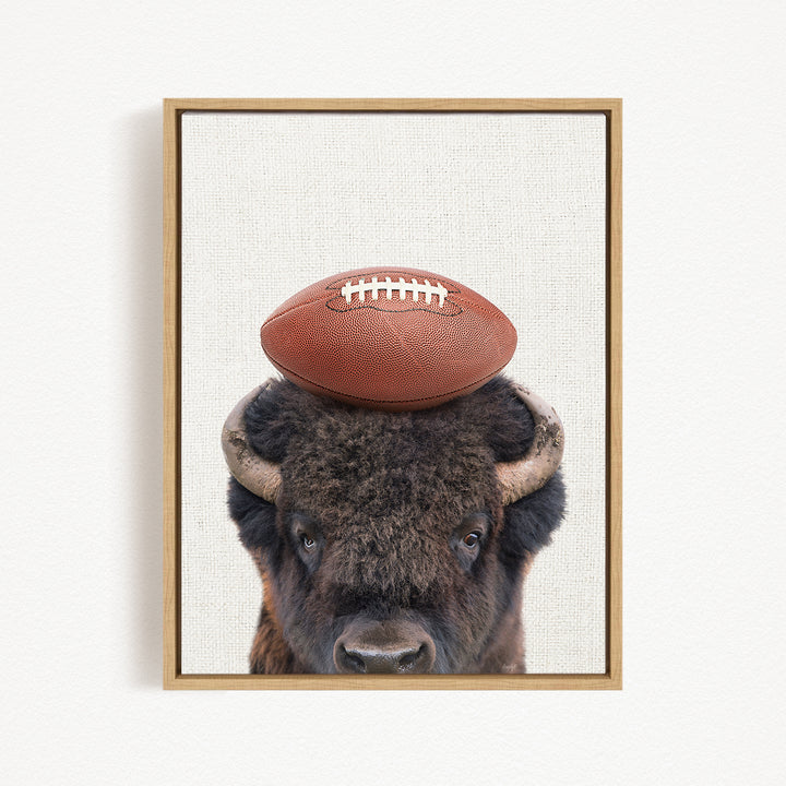 A buffalo with a football resting on its head.
