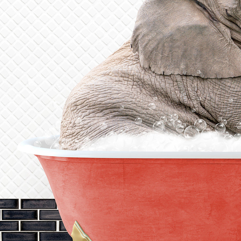 an elephant taking a bath in a red bathtub