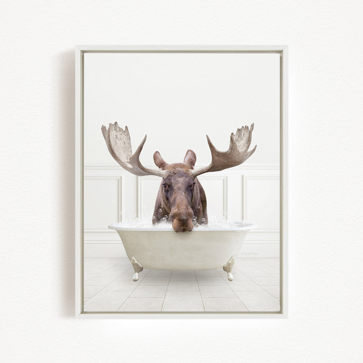 A moose with large antlers is sitting in a bathtub filled with water, creating a whimsical and humorous scene.