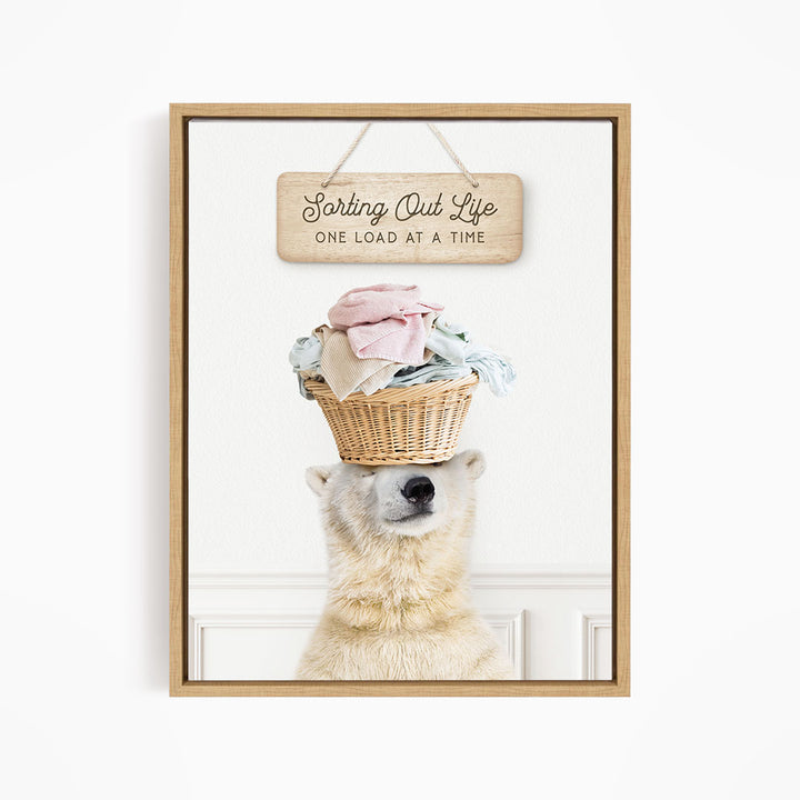 A polar bear balancing a basket of laundry on its head, with a wooden sign above that reads "Sorting Out Life One Load at a Time".
