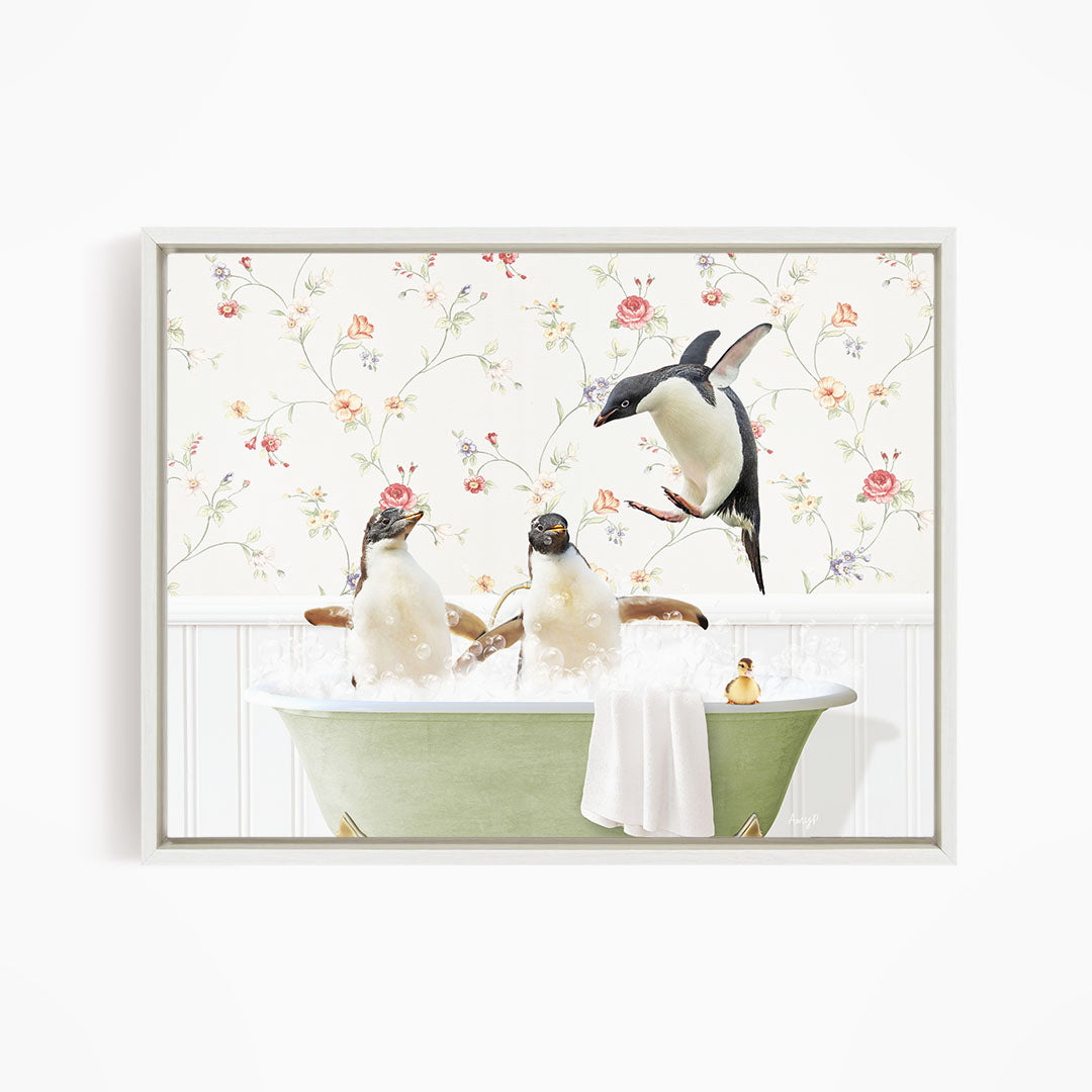A framed image depicting three penguins sitting in a bathtub, with one penguin flying towards the others.
