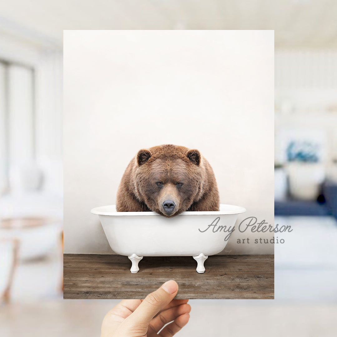 a brown bear sitting in a bath tub