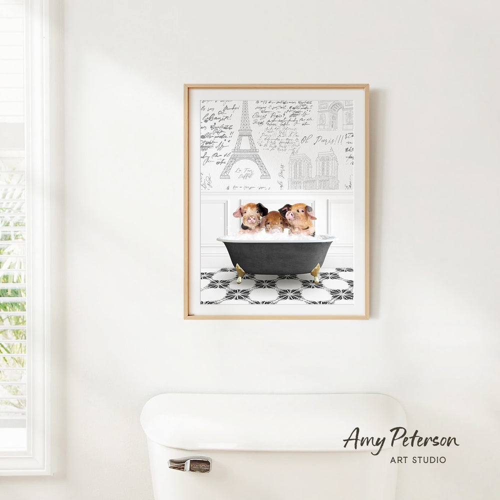 a framed print of two guinea pigs sitting in a bathtub, with a drawing of the Eiffel Tower in the background.