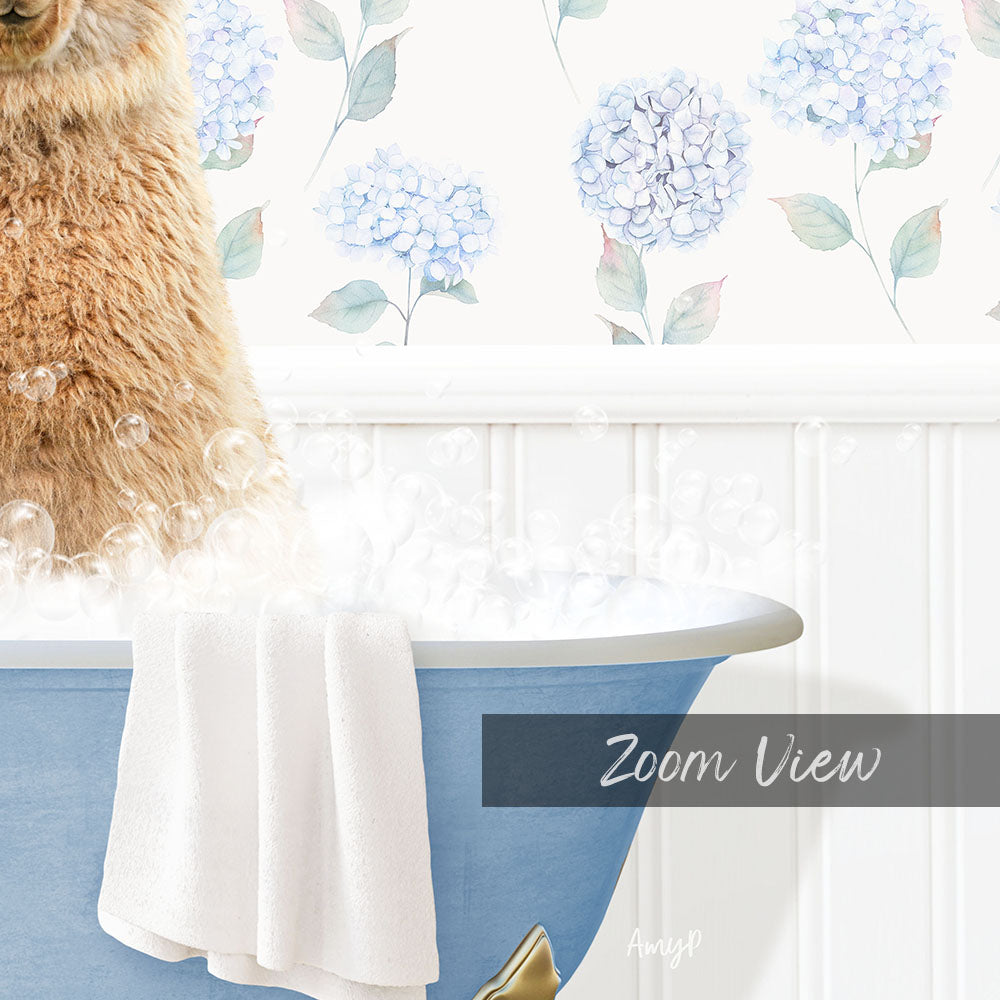 A fluffy brown dog is sitting in a blue bathtub filled with bubbles, with a towel draped over the side and a floral wallpaper in the background.