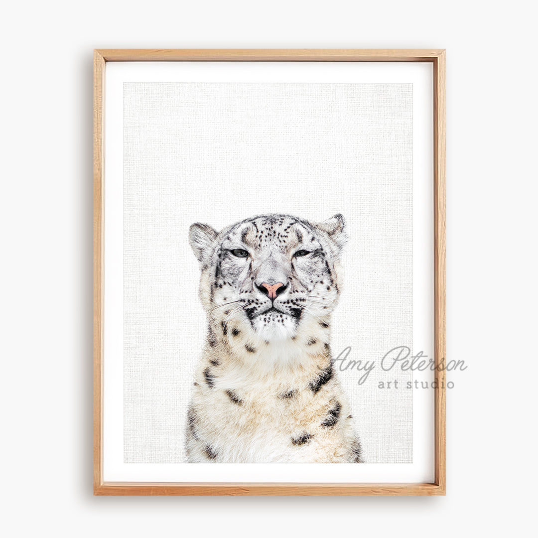 a picture of a snow leopard in a wooden frame