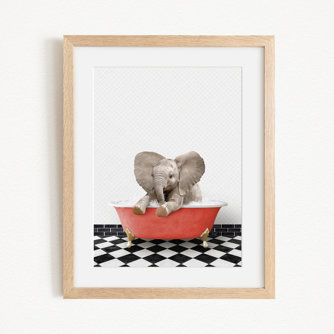 A baby elephant sitting in a red bathtub on a black and white checkered floor.