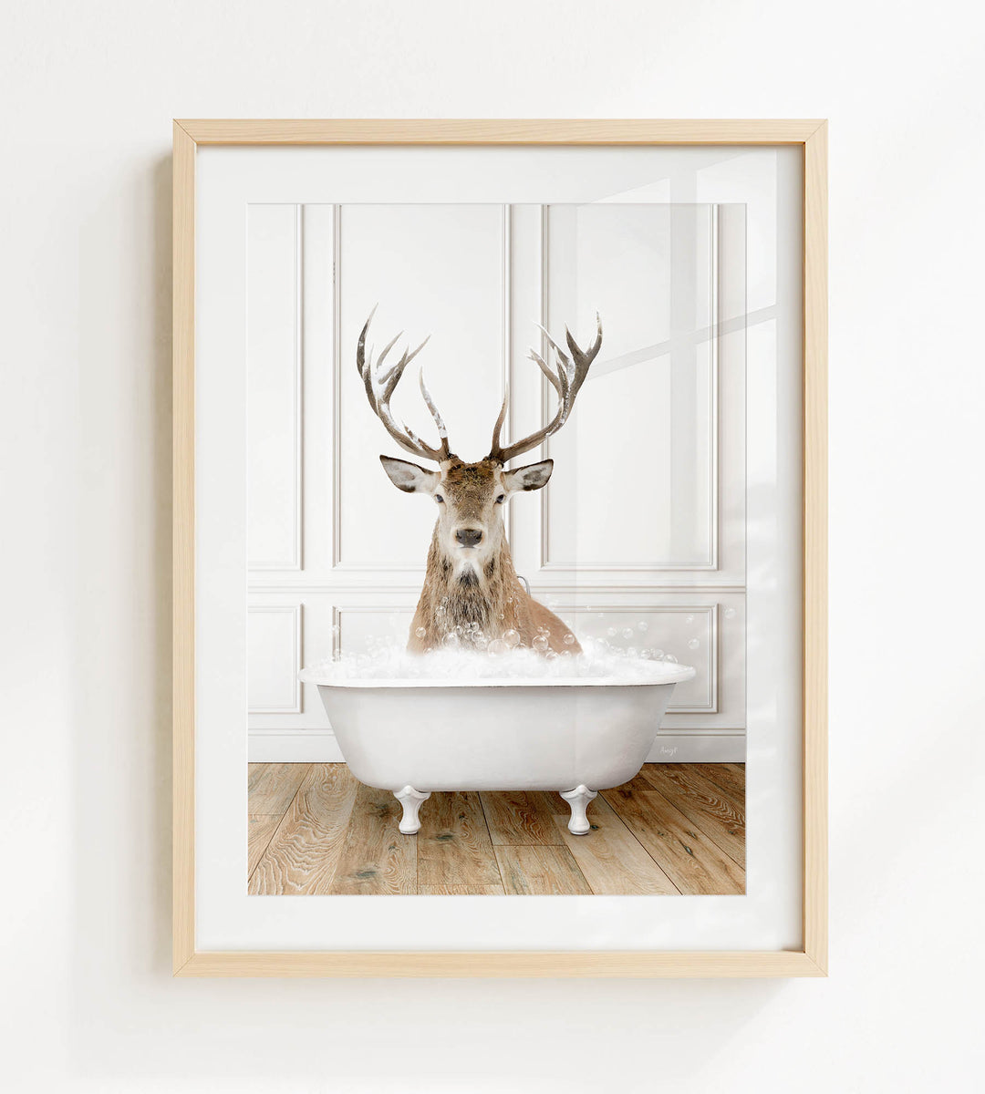 A deer with large antlers is sitting in a white bathtub filled with bubbles, creating a whimsical and unexpected scene.