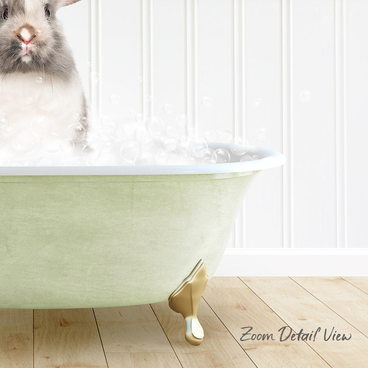 A small rabbit sitting in a green bathtub filled with bubbles, with a wooden floor and white walls in the background.