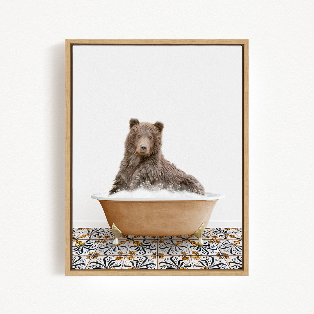 A brown bear sitting in a bathtub filled with bubbles, surrounded by a patterned tile floor.