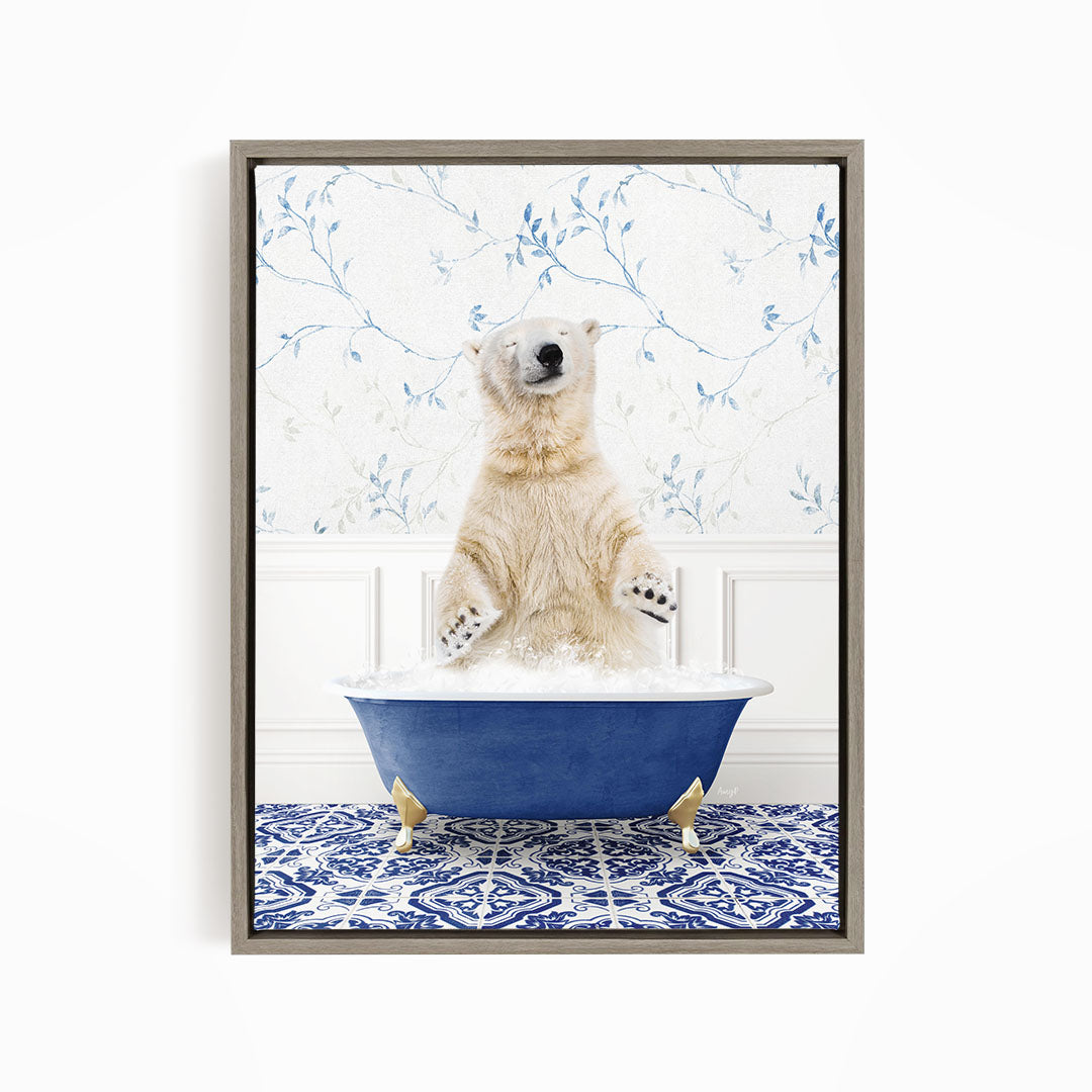 A polar bear sitting in a blue bathtub filled with bubbles, surrounded by a blue and white patterned rug.