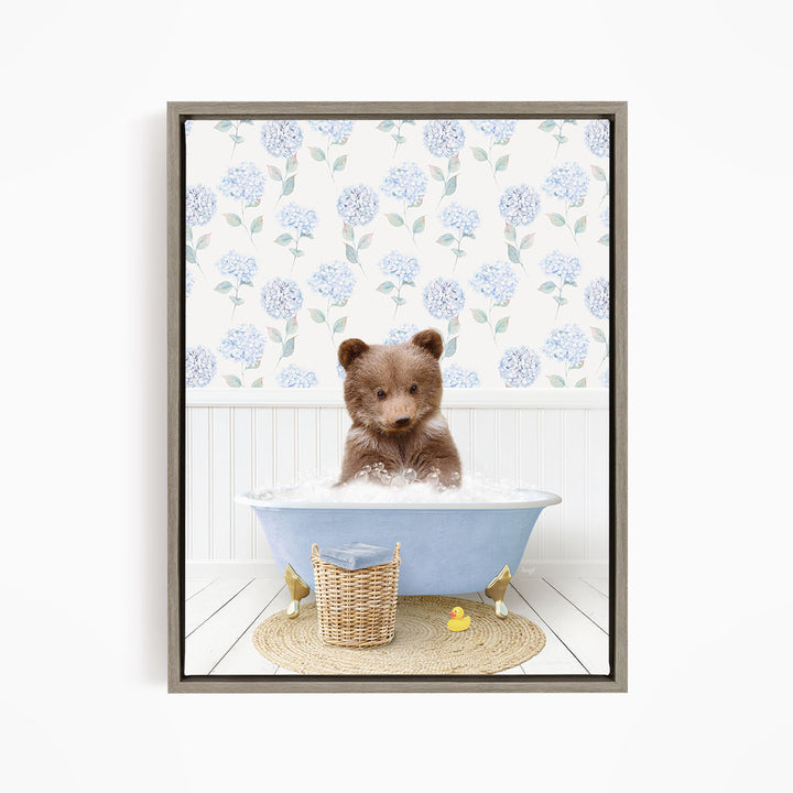 A brown bear sitting in a blue bathtub filled with water, surrounded by a wicker basket and yellow rubber ducks.