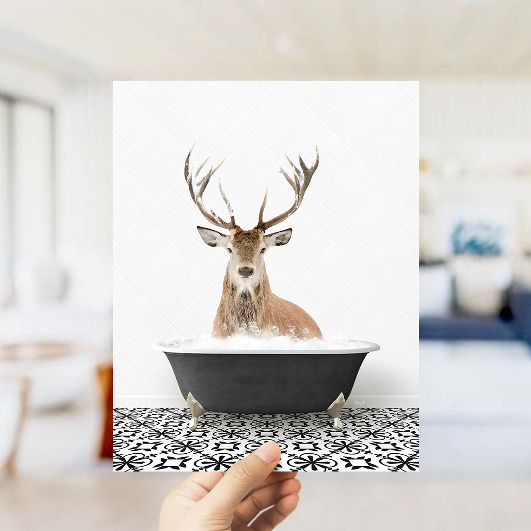 A deer with large antlers is sitting in a bathtub filled with water, creating a whimsical and unexpected scene.