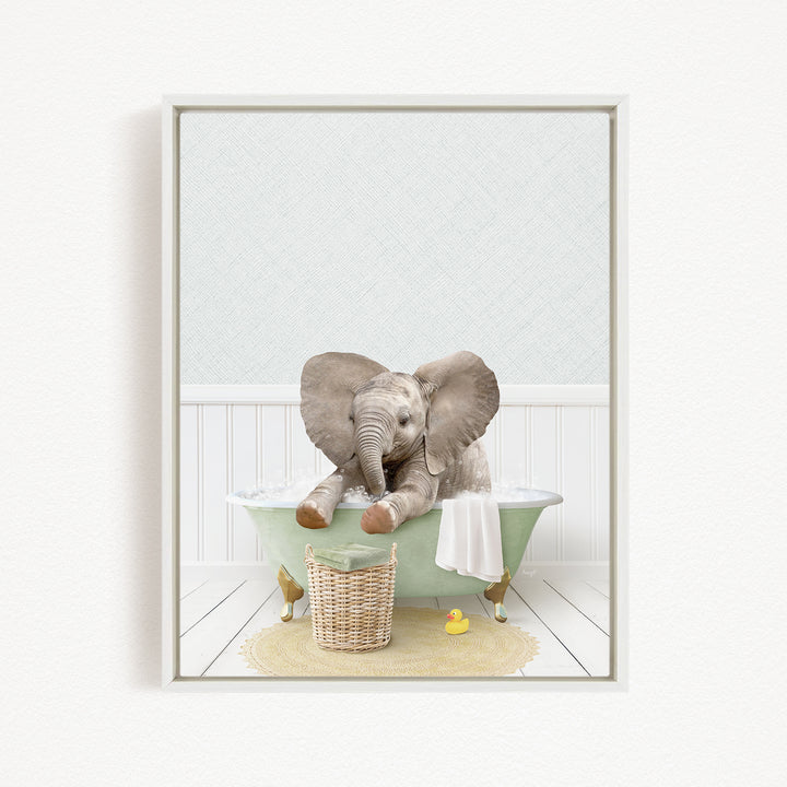 A baby elephant sitting in a green bathtub, surrounded by a basket of toys and a yellow rubber duck.