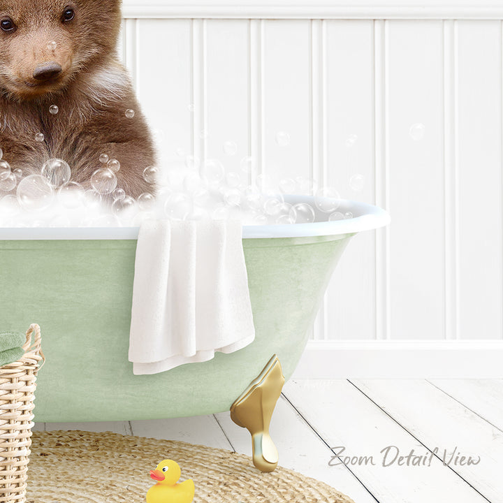 A brown bear is sitting in a green bathtub filled with bubbles, surrounded by a yellow rubber duck and a white towel.