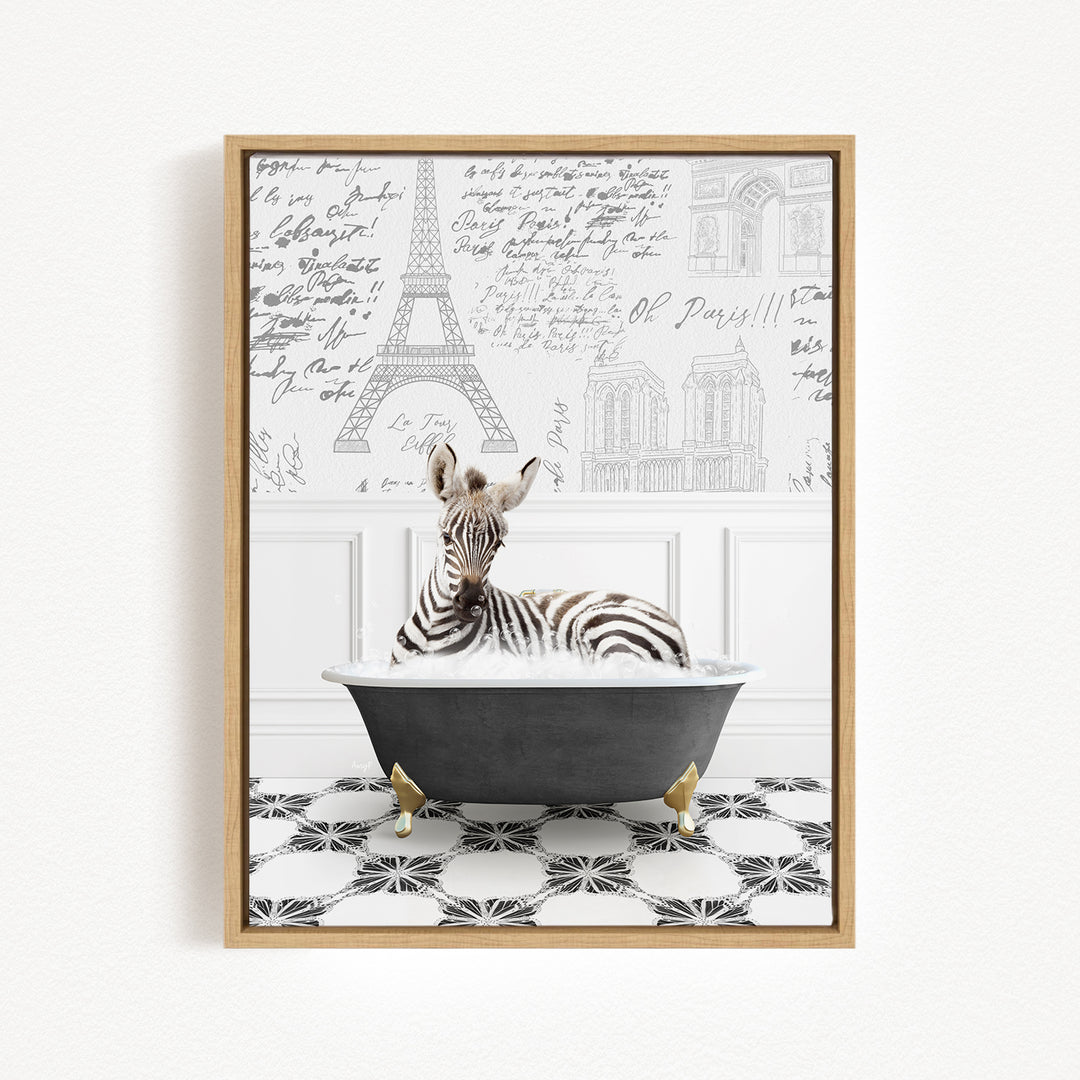 A zebra is sitting in a bathtub, surrounded by a black and white tiled floor and a wall with various inscriptions and illustrations, including the Eiffel Tower.