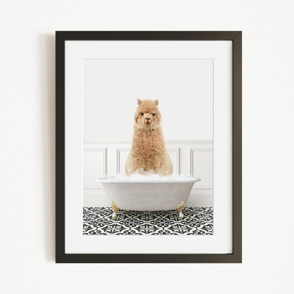 A fluffy brown dog sitting in a white bathtub filled with bubbles, surrounded by a black and white patterned rug.