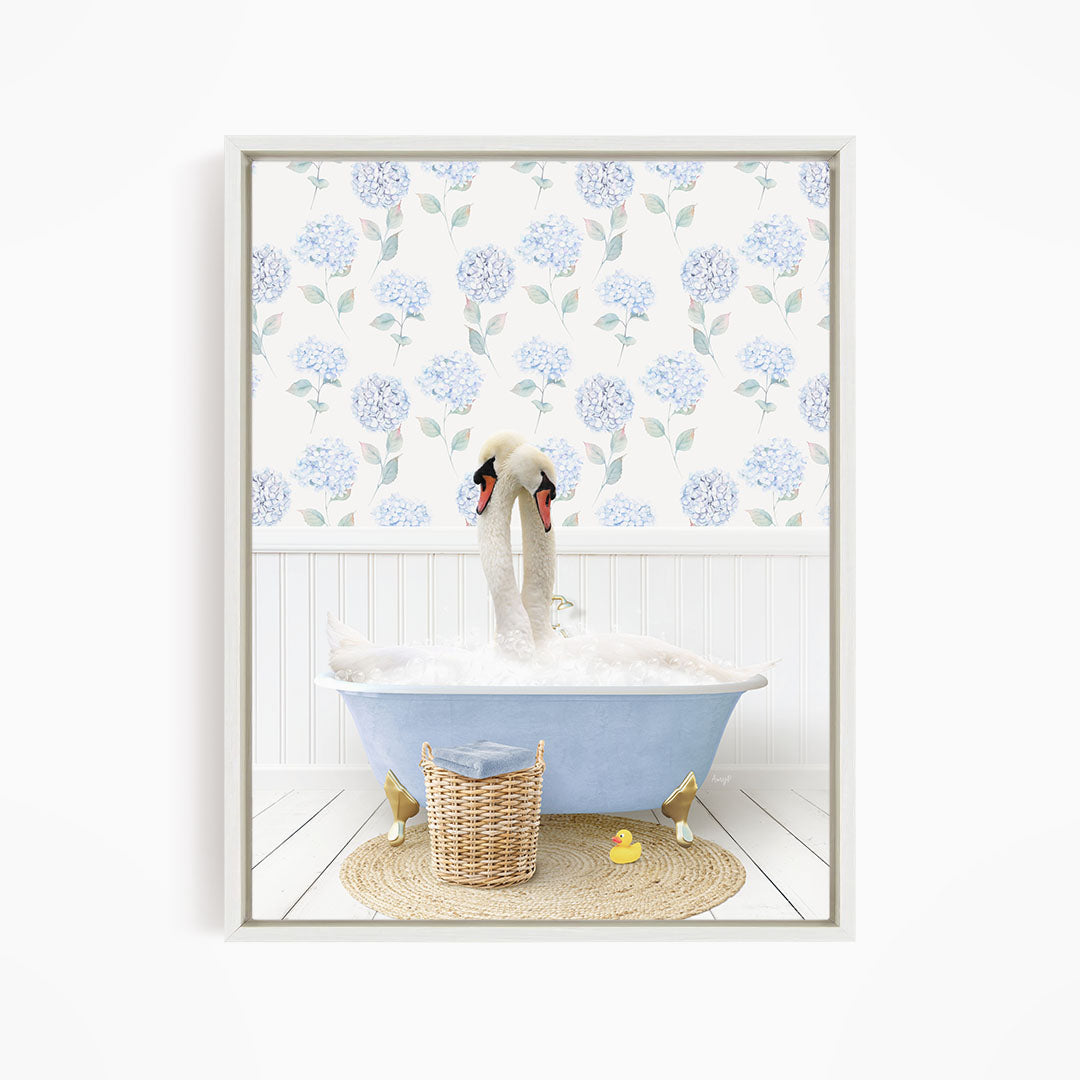 A pair of swans sitting in a blue bathtub, surrounded by a floral patterned wall and a basket of rubber ducks.