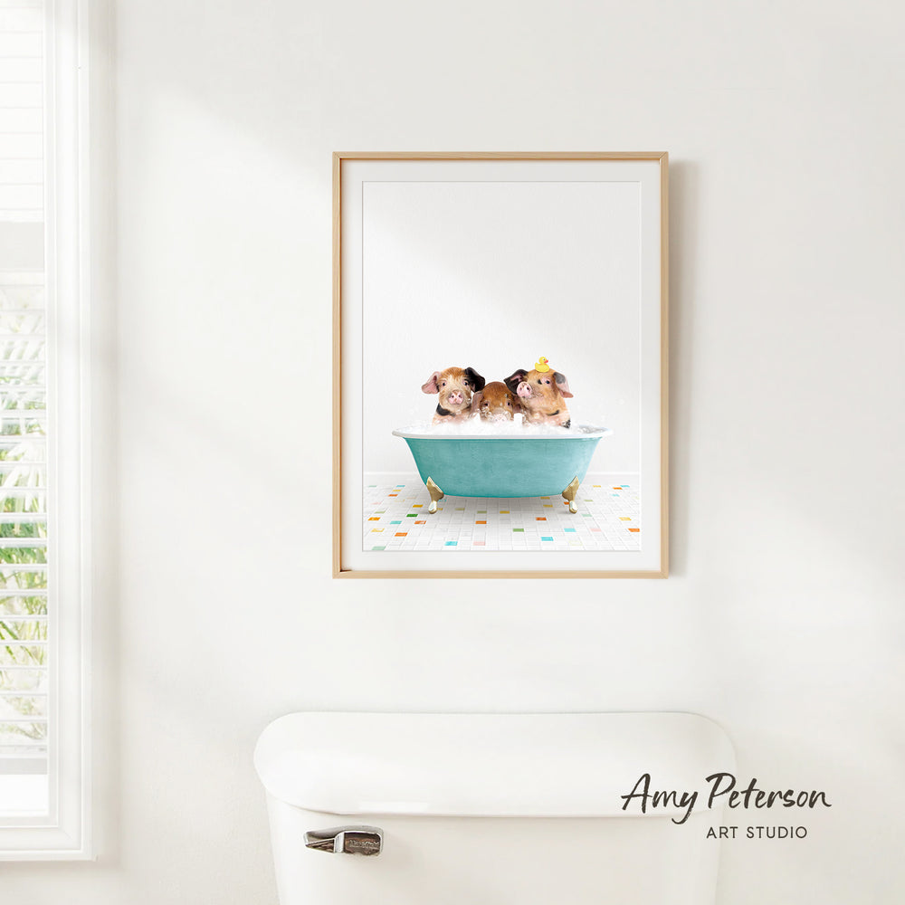 A framed image of two dogs sitting in a bathtub, with a white toilet and a window in the background.