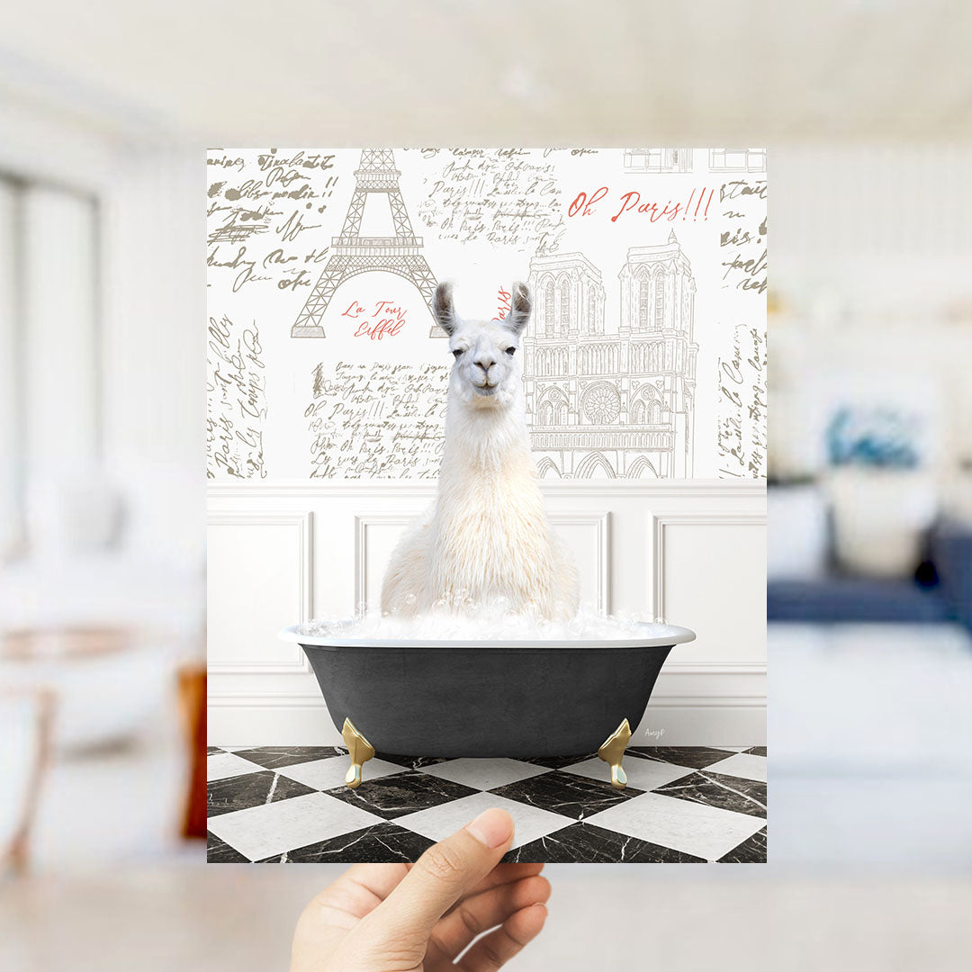 A white llama sitting in a bathtub filled with bubbles, with a Paris-themed background featuring the Eiffel Tower and other landmarks.