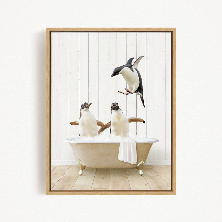 A framed image depicting three penguins sitting in a bathtub, with one penguin flying towards the others.
