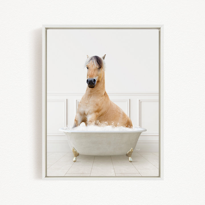 A light brown horse is sitting in a white bathtub filled with bubbles, creating a whimsical and playful scene.