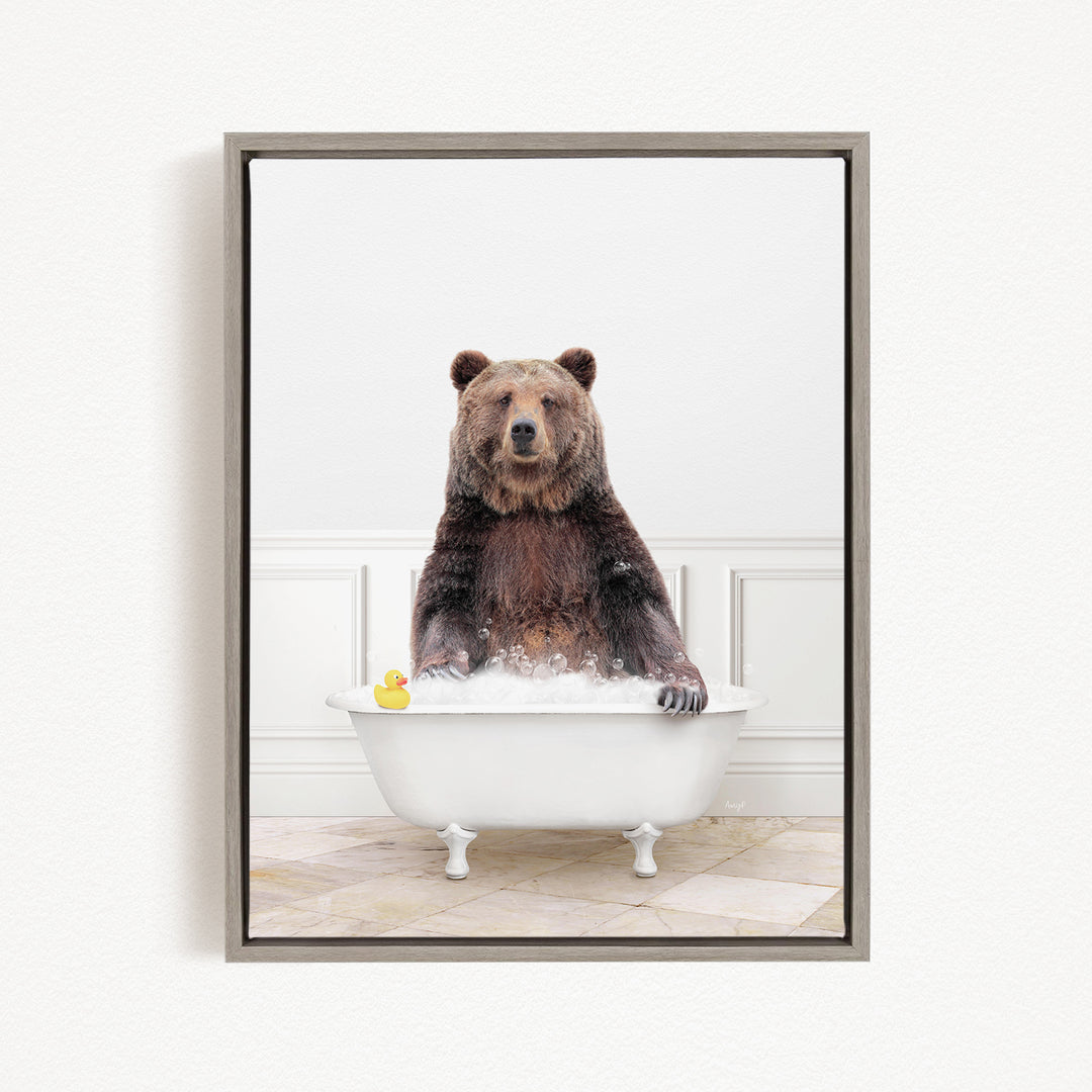 A brown bear sitting in a white bathtub, with a yellow rubber duck floating in the water.
