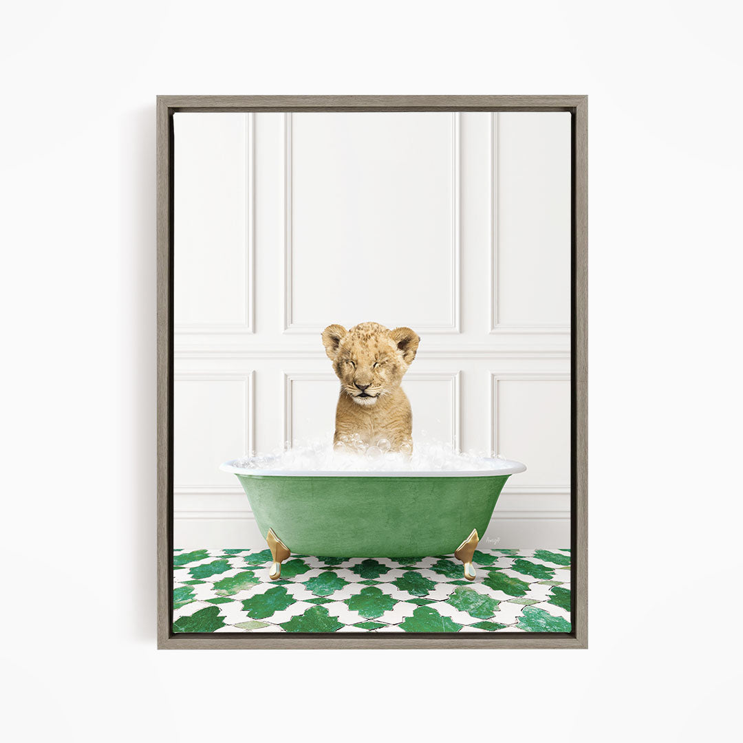 A young lion cub is sitting in a green bathtub filled with water, with its eyes closed and appearing to be enjoying the bath.