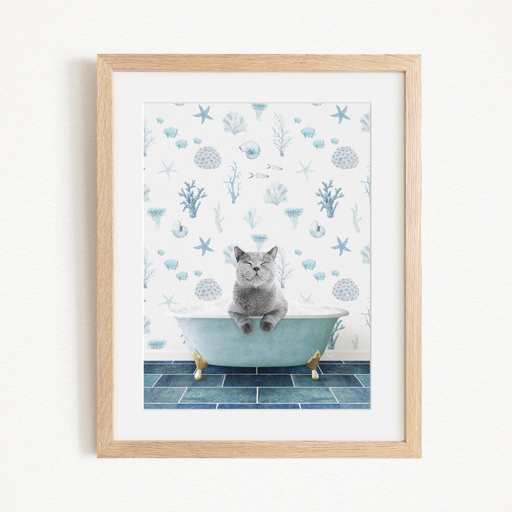 A framed print depicting a gray cat sitting in a bathtub filled with water, surrounded by various marine life and plants.