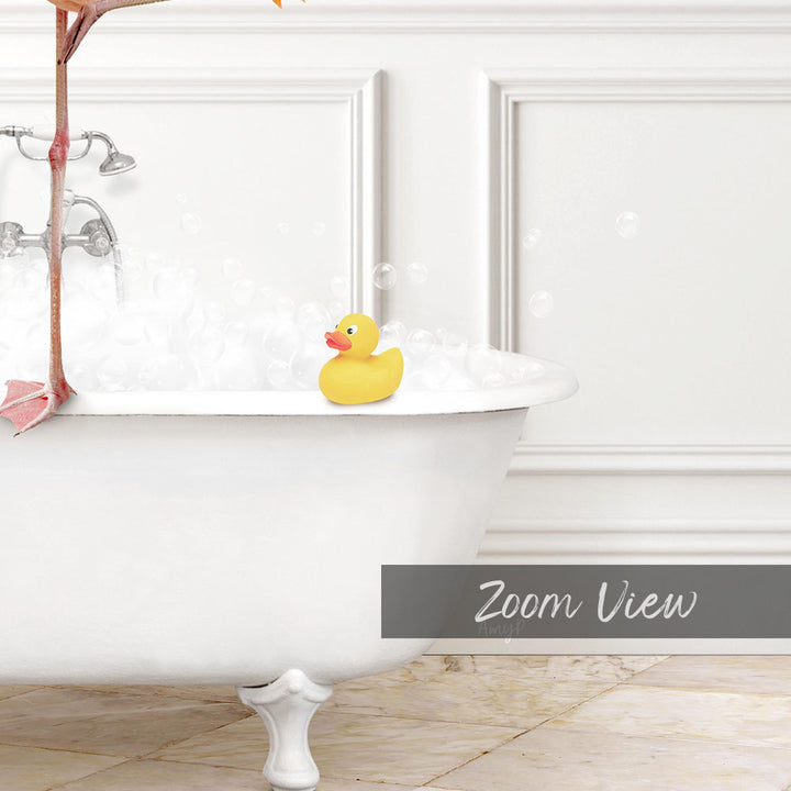 A yellow rubber duck sits in a white bathtub filled with bubbles, with a pink object hanging from the faucet.