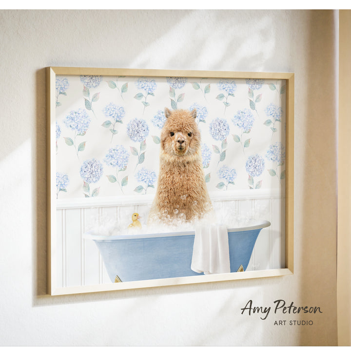 A framed image of a brown llama sitting in a blue bathtub filled with bubbles, surrounded by a floral pattern.