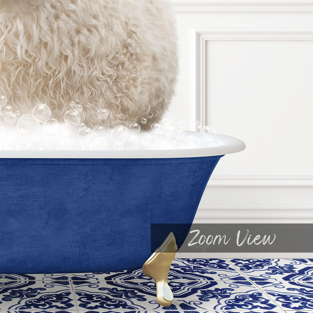 A fluffy white dog is sitting in a blue bathtub filled with bubbles, with a gold faucet and a white wall in the background.