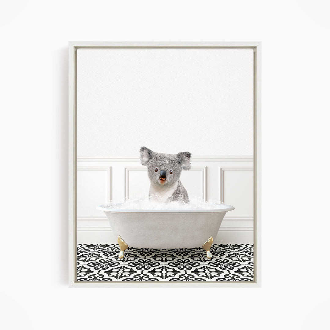 A koala bear sitting in a bathtub filled with water, surrounded by a black and white patterned floor.