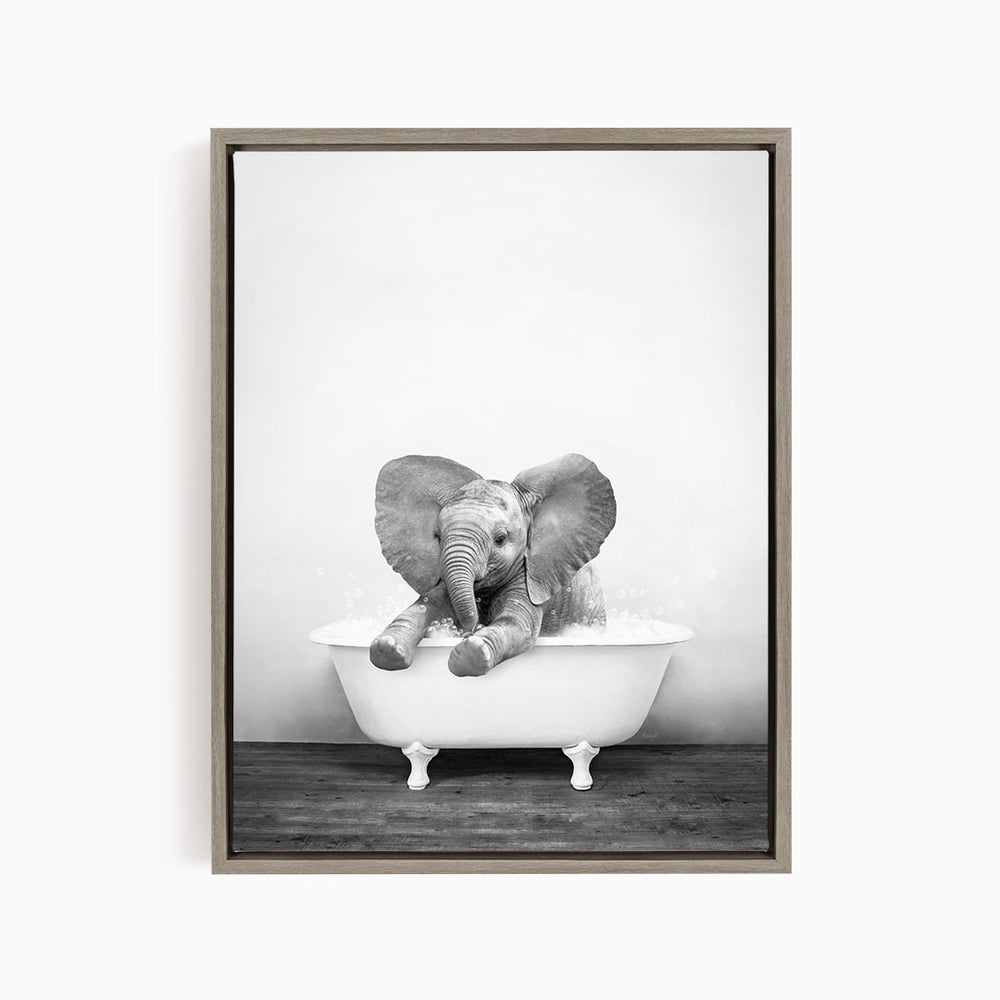 A baby elephant sitting in a bathtub filled with water, creating a playful and whimsical scene.