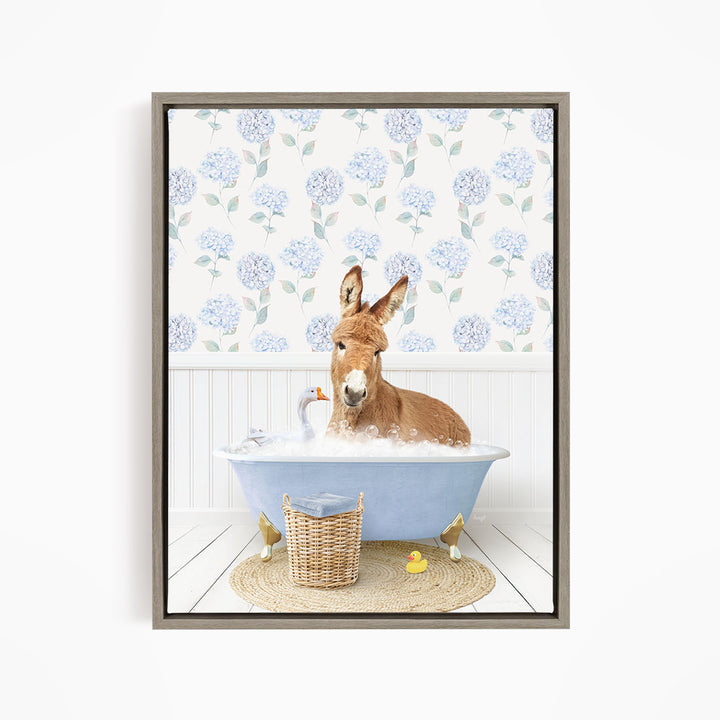 A donkey is sitting in a blue bathtub filled with water, surrounded by a basket of toys and a yellow rubber duck.