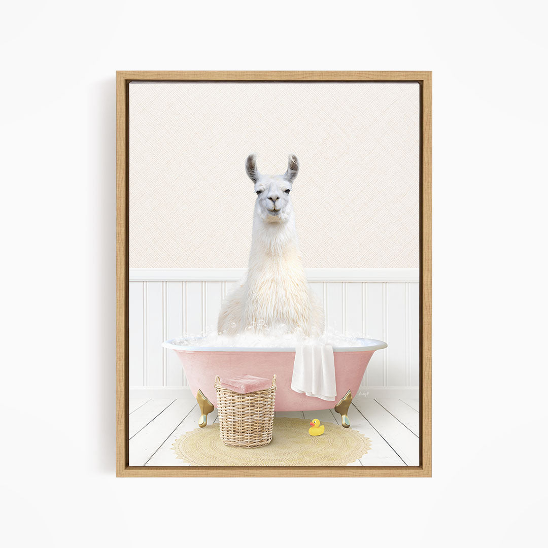 A white llama sitting in a pink bathtub filled with bubbles, surrounded by a yellow rubber duck and a wicker basket.