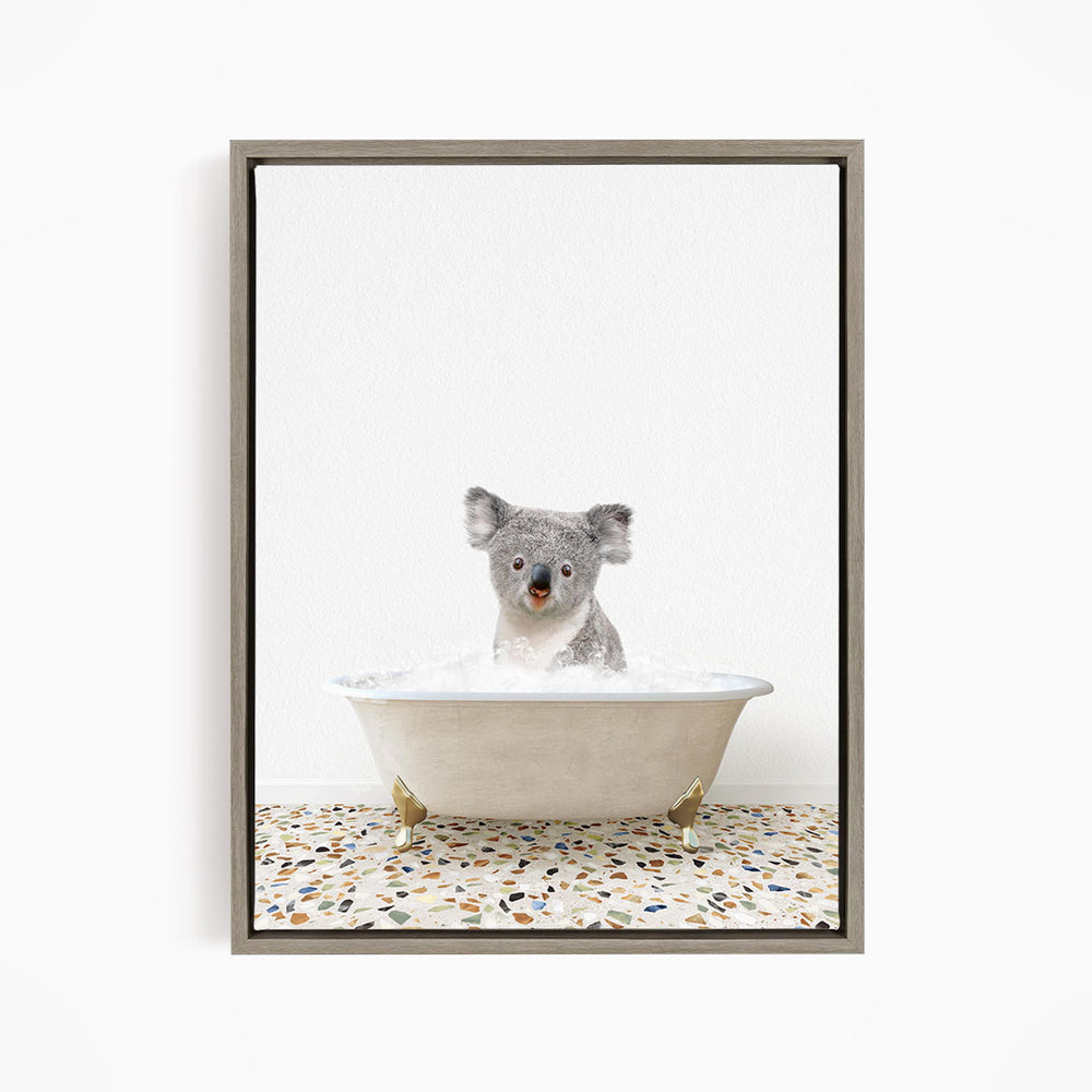 A koala bear sitting in a bathtub filled with water, looking directly at the camera.